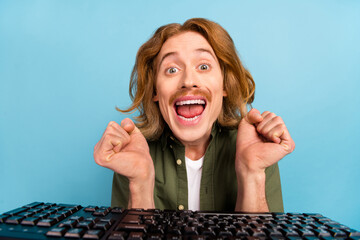 Portrait of attractive funky crazy cheerful guy geek using computer having fun isolated over pastel...