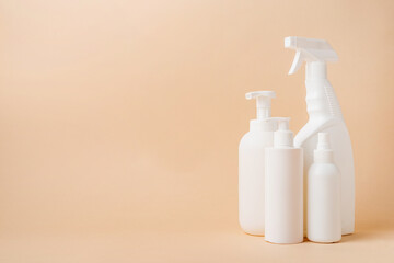 Group of white blank packaging tubes and containers for cosmetics on beige natural color background, mockup design, eco friendly