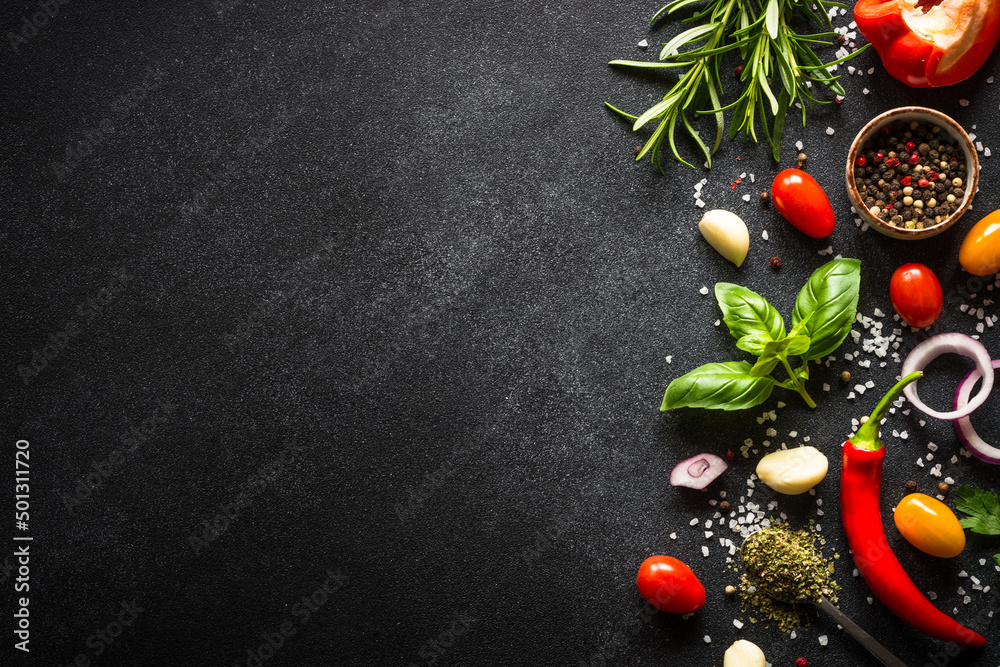 Sticker food background on black stone table with fresh vegetables, herbs and spices. ingredients for cookin