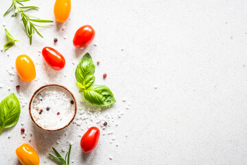 Food cooking background on white stone table. Fresh vegetables, herbs and spices. Ingredients for...