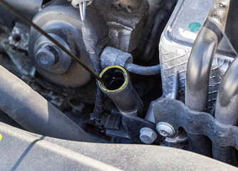 Oil dipstick in a diesel engine. Engine breakdown from low oil level, industry