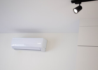 Modern wall-mounted air conditioner in the apartment with heating and cooling capacity of the room. Comfortable temperature. Copy space for text