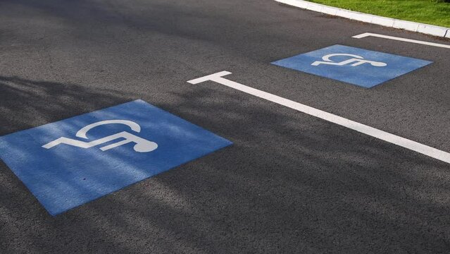 4k video with parking places made special for people with disabilities. Parking lot and traffic infrastructure.