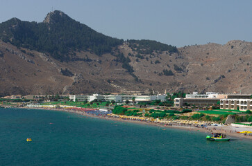 Popular beach line in Kolympia with hotel infrastructure and Tsampika mountain view in the distance (Rhodes, Greece)