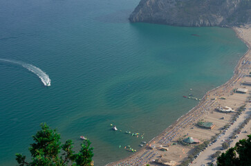 Bay of the famous Tsampika beach with lots of sunbeds and parking for cars top view (Rhodes, Greece)