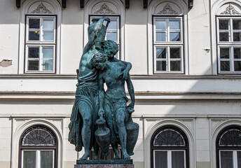 Obraz premium The ancient Fountain of the Danaides in the old town of Budapest, Hungary Eastern Europe. Bronze nymphs with jars, beautiful greek mythological figures.