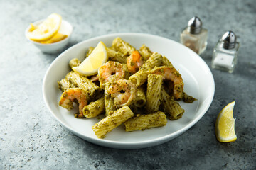 Pasta with pesto sauce and shrimps