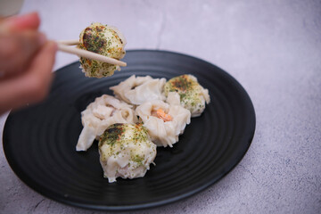 dim sum food served on a black plate