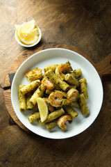 Pasta with pesto sauce and shrimps