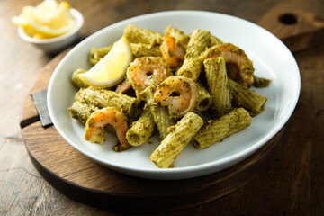 Pasta with pesto sauce and shrimps