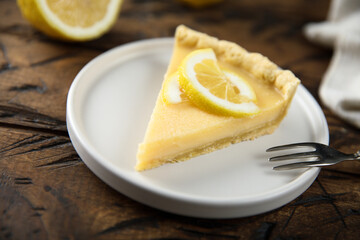 Traditional homemade lemon tart on a white plate