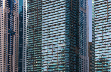 Fototapeta na wymiar Close up of glass modern skyscrapers in Dubai Marina, full frame