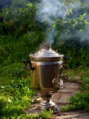 Ketler Samovar boiling water in the fresh air summer garden