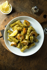 Pasta with pesto sauce and shrimps