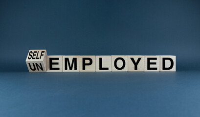 Cubes form the words Unemployed or Self employed. Concept of business and employment