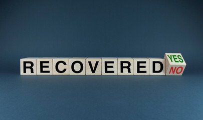 Recovered no or Recovered yes. The dice form the selection words Recovered no or yes.