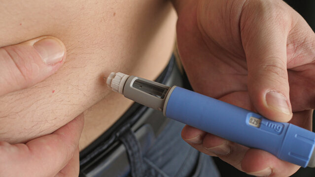 obese fat man injecting Semaglutide Ozempic injection control blood sugar levels