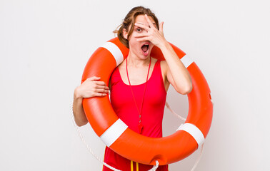 young pretty woman  looking shocked, scared or terrified, covering face with hand. lifeguard concept