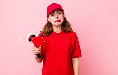 young pretty woman  feeling sad and whiney with an unhappy look and crying. company packer employee