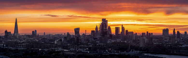 Very wide, panoramic sunset view over the modern cityscape of London, England
