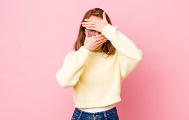 young pretty woman covering face with both hands saying no to the camera! refusing pictures or...