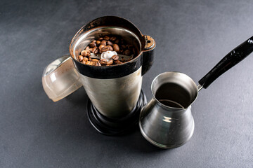 Roasted coffee beans in a coffee grinder