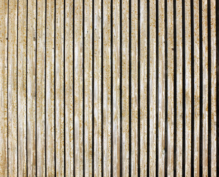 old textured cast concrete wall with vertical lines and striped design