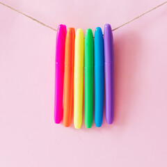 Highliter pens strung and ordered in rainbow colors. Minimal colorful concept.