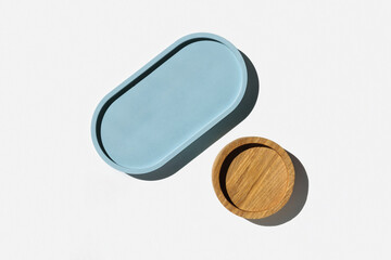 Podium for cosmetic product presentation. Abstract minimal geometrical form on white background. Oval stone form, shadow. Scene, Showcase, display. Minimal design. Trendy sunlight. Flat lay, Top View