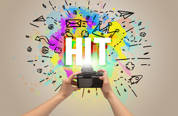 Close-up of a hand holding digital camera with abstract drawing