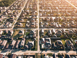 Aerial view of a luxurious village with smooth rows of two-storey duplex houses. Neighborhood in...