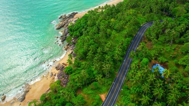 Drones are flying over beautiful beaches, roads and seas. The Gulf of Thailand. The turquoise waters are unique to the tropical seas. many coconut trees. Khanom-Sichon road. Nakhon Si Thammarat, Thail