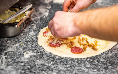 hand of chef baker making pizza at kitchen. The process of making pizza. cooking italian pizza
