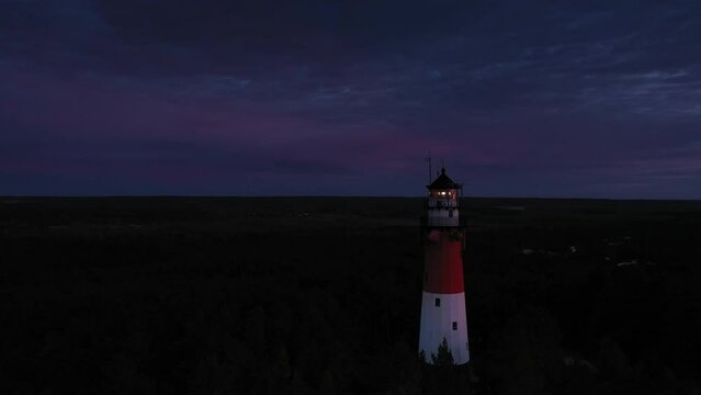 Aerial view of the lighthouse in the evening. Blue sky, pastel clouds.