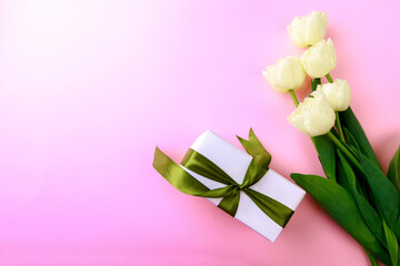Gift box and spring flowers on pink background. Stylish soft image of spring flowers. Happy womens day. Happy Mothers day.Hello Spring- Image