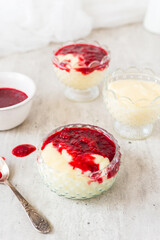 Homemade vanilla pudding with white chocolate and raspberry sauce