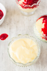 Fototapeta na wymiar Homemade vanilla pudding with white chocolate and raspberry sauce