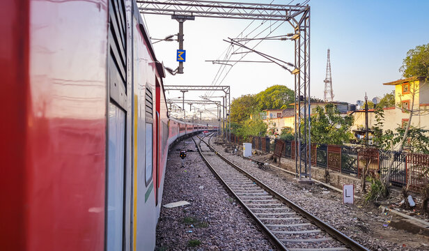 train running on railway track with flat sky at morning from different angle