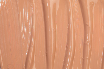 Fototapeta premium Beige nude liquid foundation texture, concealer smear smudge drop. Closeup macro. Cosmetic tonal makeup moisturizer, bb cream swatch sample.- Image