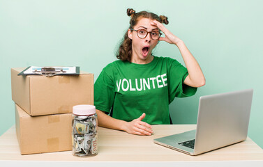 young pretty woman  looking happy, astonished and surprised. donation volunteer concept