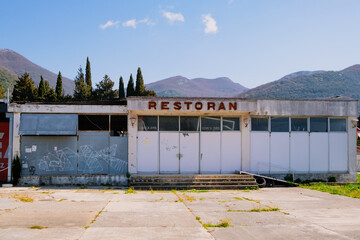 old vintage closed abandoned rural building of a restaurant near  road among mountains landscape....