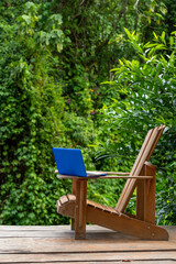 A laptop on a adirondack chair in a rainforest lodge, digital nomad concept, Chiriqui province,...