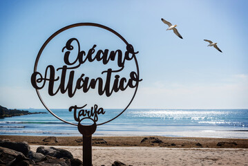 Monument to the Atlantic Ocean located in Tarifa Cadiz Spain with the sea in the background and two seagulls in the sky © Fran Rodríguez