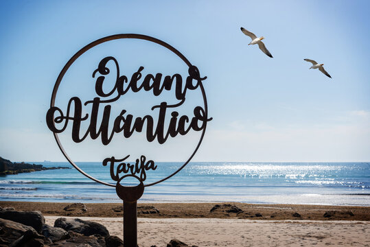 Monument to the Atlantic Ocean located in Tarifa Cadiz Spain with the sea in the background and two seagulls in the sky