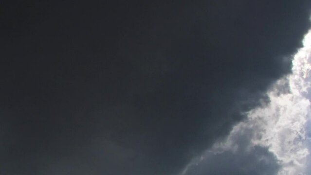 Beautiful blue sky with sunbeams and clouds timelapse.