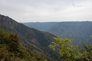 mountain valley covered with white mists and haze at morning from flat angle