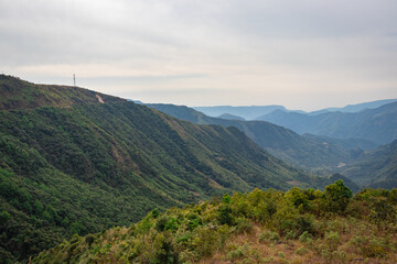 Naklejka premium mountain valley covered with forest and white mists at morning from flat angle