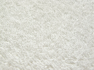 Close-up of a towel terry cloth. White fabric and texture concept. White towel macro material.