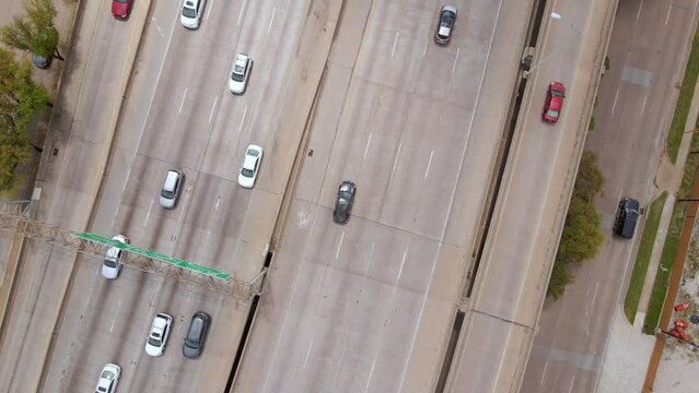 Aerial view above traffic on the Woodall Rodgers freeway, in sunny Dallas, USA - top down, drone shot
