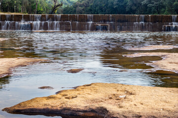 Obraz premium river water streams falling from stairs at morning from flat angle